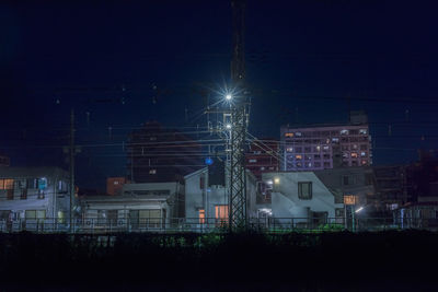 Low angle view of illuminated buildings against sky at night