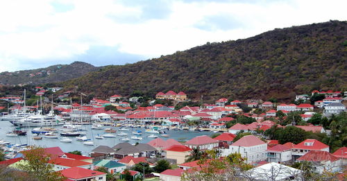 High angle view of townscape by mountain against sky