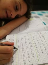 High angle view of girl studying at table