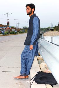 Low angle view of young man standing on street