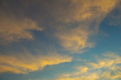 Low angle view of cloudy sky at sunset