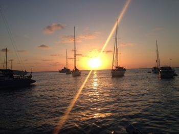 Sailboat on sea at sunset