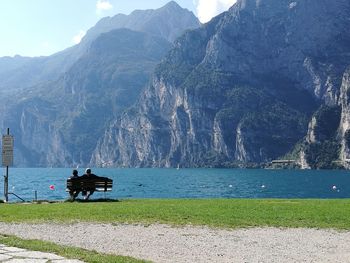 Scenic view of lake by mountain against sky