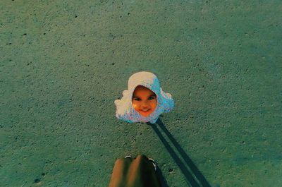 High angle portrait of girl standing against wall