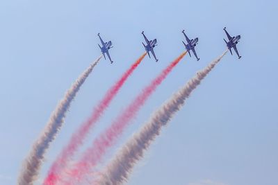 Low angle view of airplane flying against sky