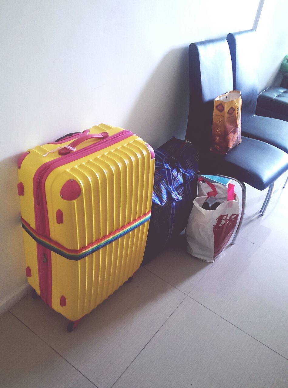 indoors, high angle view, transportation, day, no people, copy space, flooring, relaxation, multi colored, tiled floor, absence, sunlight, still life, sitting, wall - building feature, travel, close-up, yellow, home interior, seat