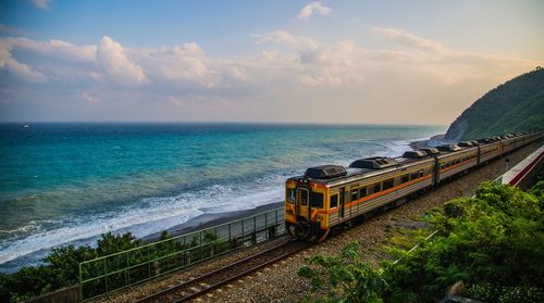 High angle view of train by sea during sunset