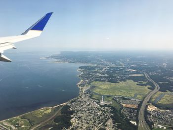 Aerial view of airplane wing over landscape