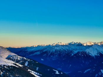 Scenic view of snowcapped mountains against clear blue sky