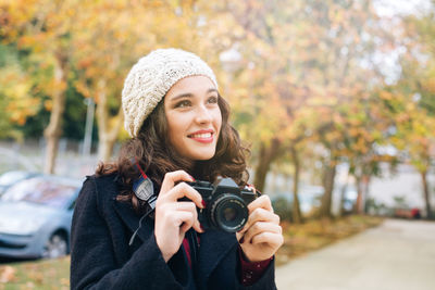 Portrait of smiling young woman wearing hat