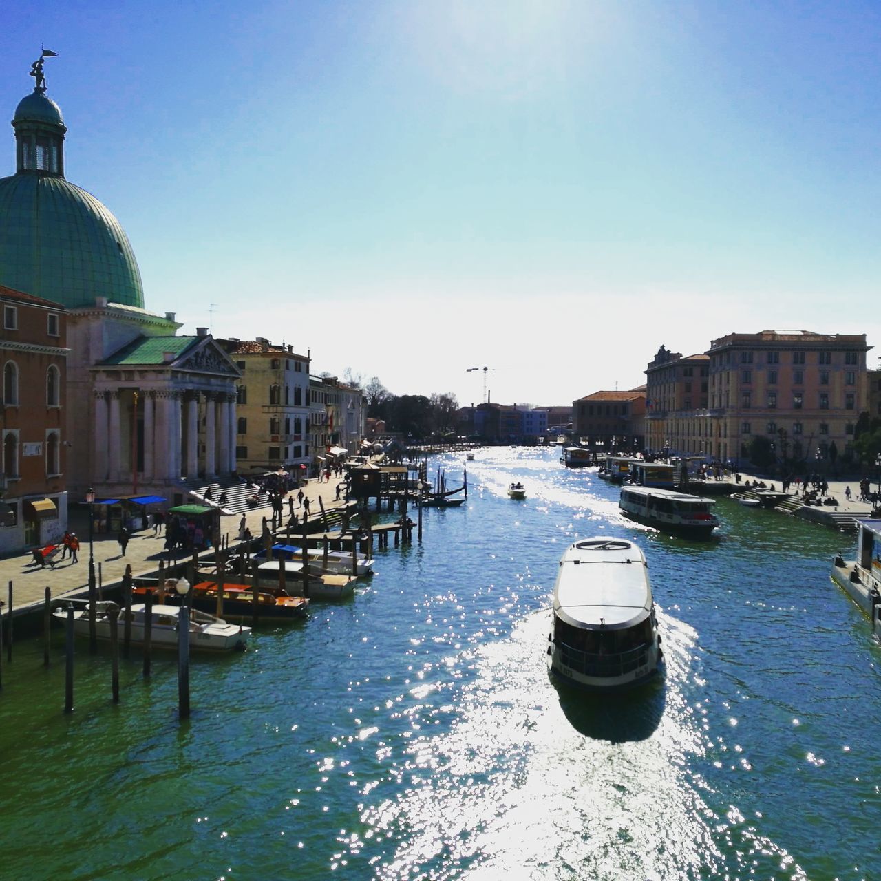 building exterior, architecture, water, built structure, nautical vessel, clear sky, transportation, city, mode of transport, sky, moored, travel destinations, outdoors, no people, dome, harbor, day, cityscape, yacht