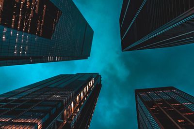 Low angle view of modern buildings against sky at night