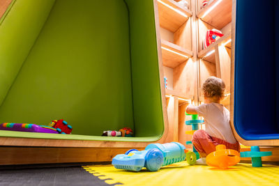 High angle view of girl playing with toys