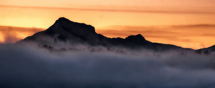 Scenic view of mountains against sky during sunset