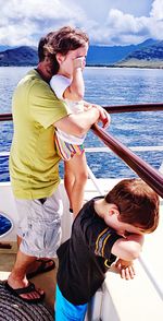 Father with daughter and son standing on boat