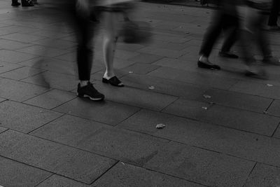 Low section of people walking on footpath