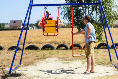 Boy swinging at playground