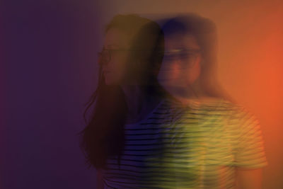 Digital composite image of silhouette woman standing against gray background