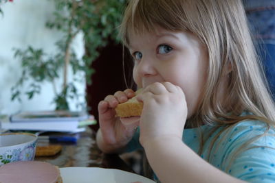 Portrait of cute girl eating food