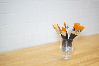 Close-up of wineglass on table against wall