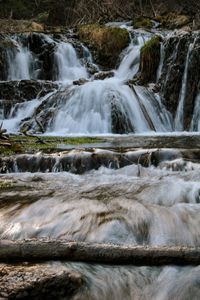 Scenic view of waterfall against sky