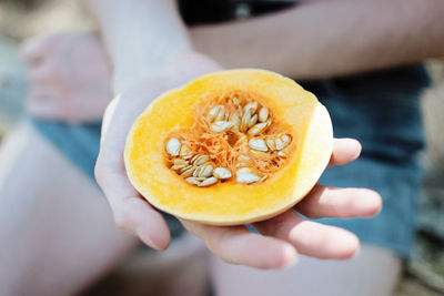Midsection of boy showing pumpkin slice