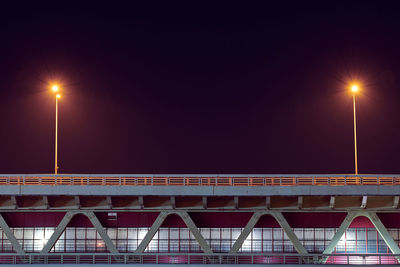 Night rapid transit bridge lighting. minimalistic light, copy space. two lamppost with yellow lights