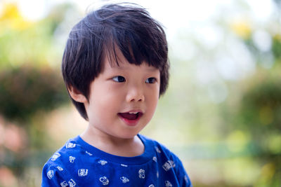 Close-up of cute boy looking away