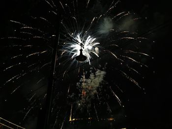 Low angle view of firework display at night