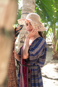Portrait of young woman wearing hat