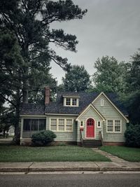 House by building against sky