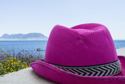 Close-up of hat on beach against sky