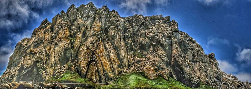 Low angle view of rock formation against sky