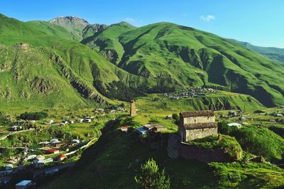 Scenic view of agricultural field and mountains against sky