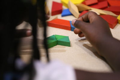 Close-up girl playing with toy blocks on table