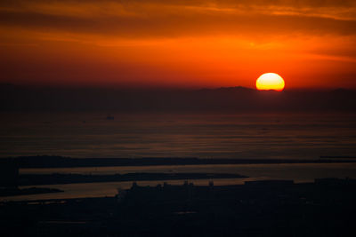 Scenic view of sea against orange sky