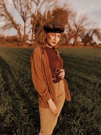 Young woman looking away on field