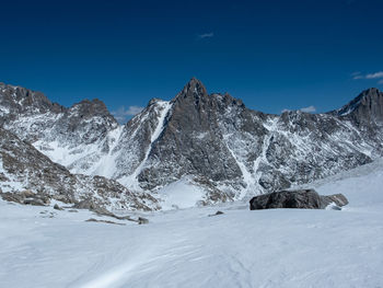 Scenic view of snowcapped mountains against blue sky