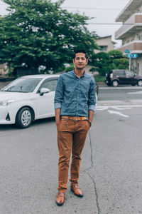 Full length of young man standing on road