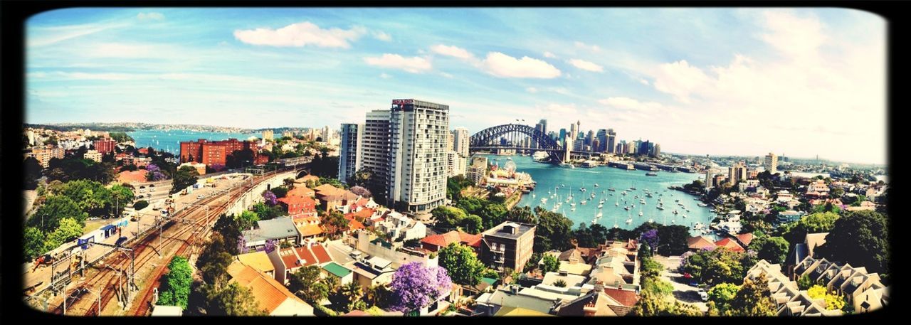 building exterior, architecture, transfer print, city, built structure, cityscape, sky, auto post production filter, high angle view, crowded, water, panoramic, cloud - sky, residential district, sea, cloud, city life, skyscraper, tower, residential structure