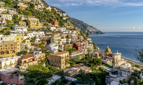 High angle view of townscape by sea against sky