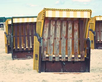 Lifeguard hut on beach against sky