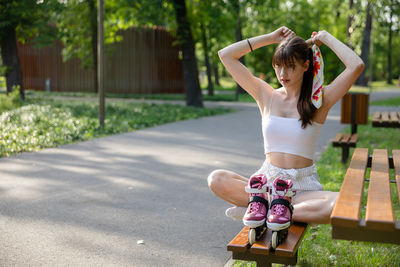 Low section of woman standing on road