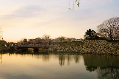 Scenic view of lake against sky during sunset