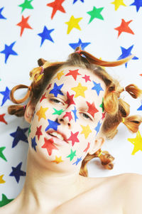 Close-up of woman with colorful star shape face paint