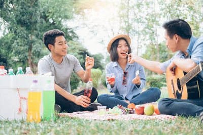 Young couple sitting on food outdoors