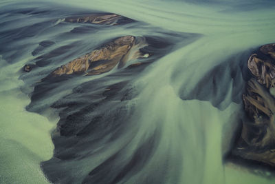 High angle view of water flowing through rocks