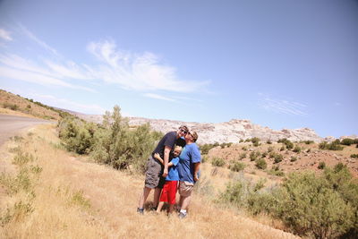 Family posing on grassy landscape