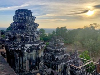 Temple against buildings at sunset