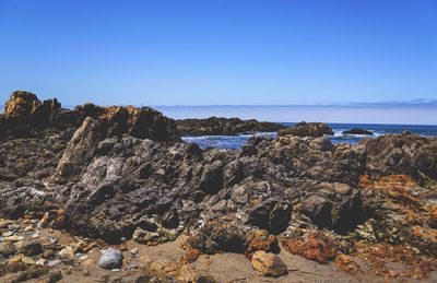 Scenic view of sea against clear blue sky